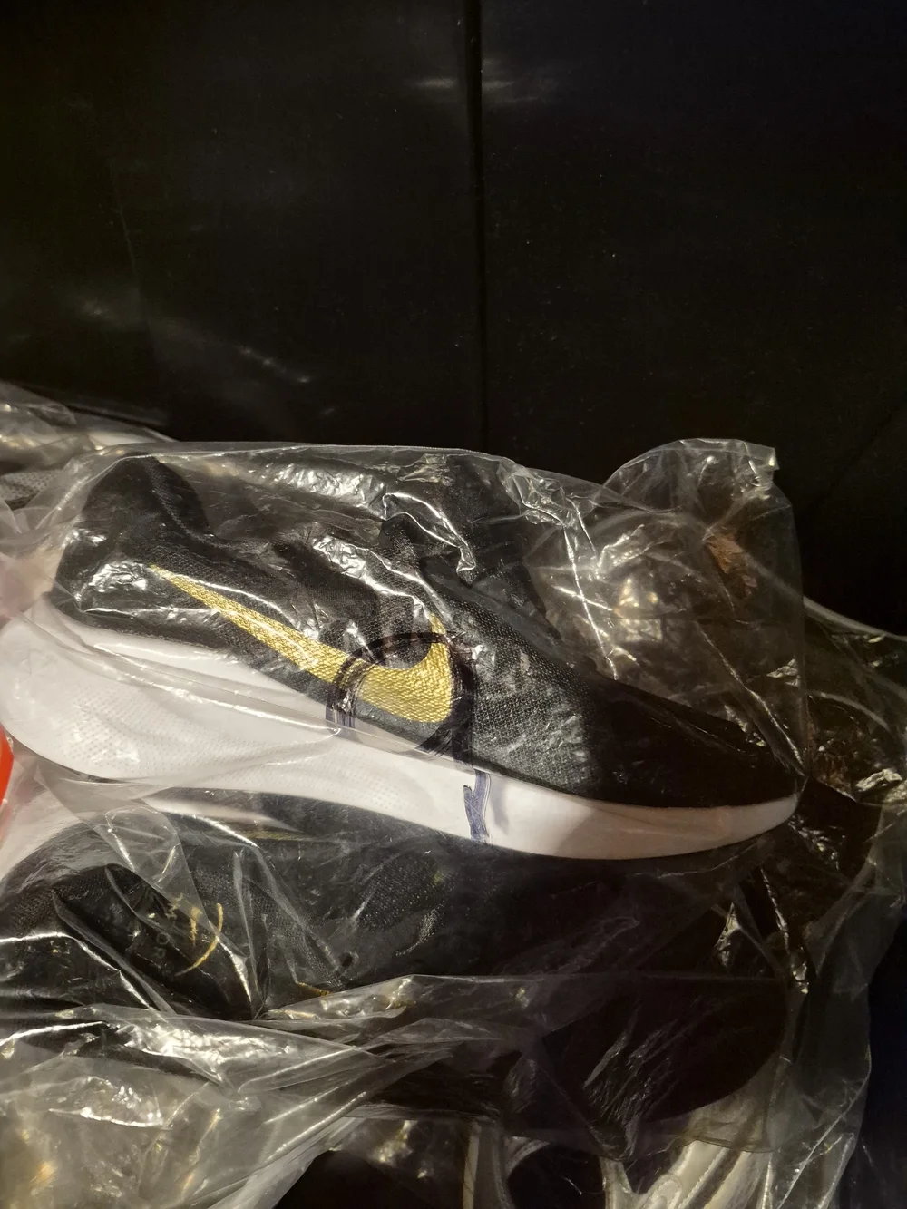Nike Black Slip-On Sneakers with Gold Swoosh